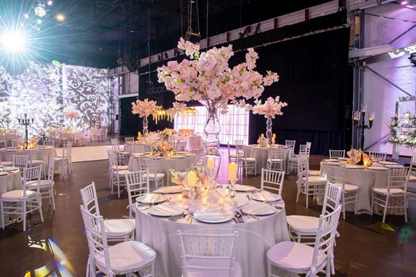 Aerial view of Bürgerhaus Krebeck — a red-brick building with a sloped roof, surrounded by green lawns and trees.